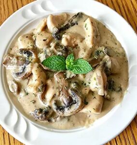 Creamy chicken and mushroom casserole in a baking dish